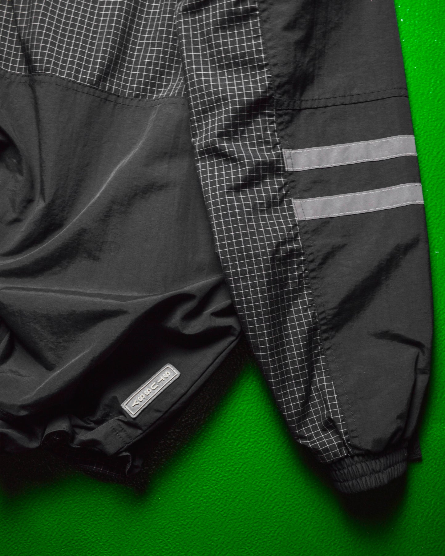 International Grid  Reflective Panelled  Shell Jacket (M)