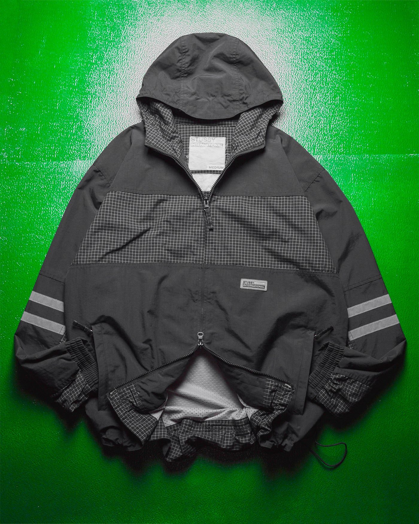 International Grid  Reflective Panelled  Shell Jacket (M)